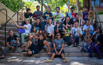 Students sitting with electric guitars.